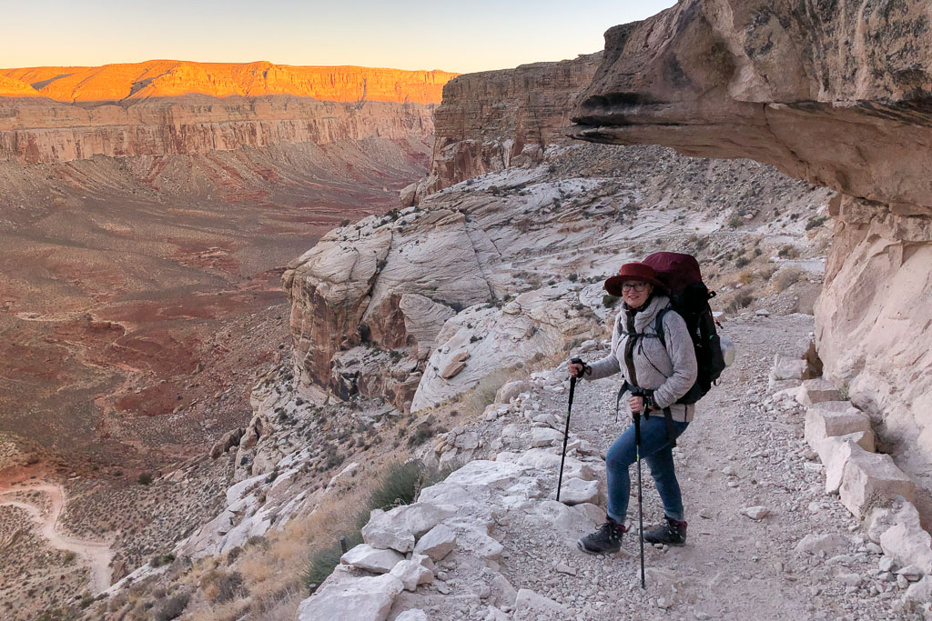 Agnes Stabinska, the author, hiking to Havasu Falls with a backpack, trekking poles, hiking boots, and a fleece jacket.