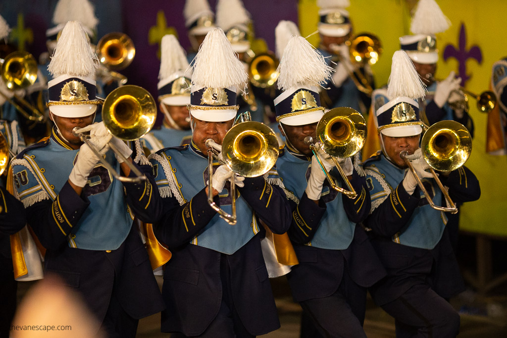 Mardi Gras New Orleans Itinerary: a marching band marches down the street.