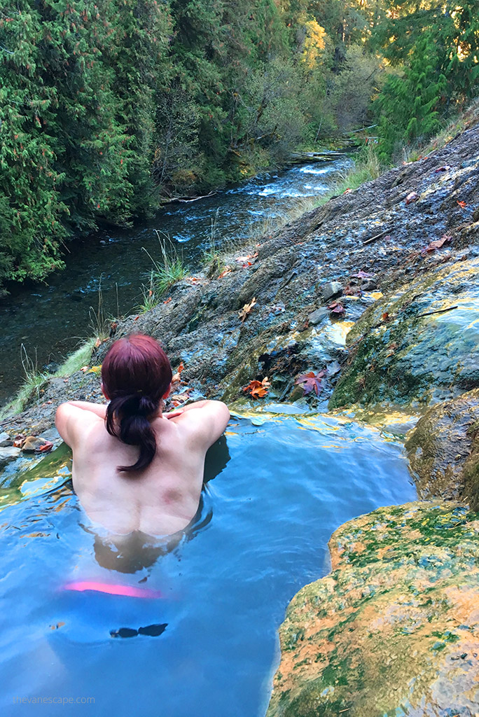 Agnes Stabinska, the author, is soaking in Umpqua Hot Springs with the forest view.