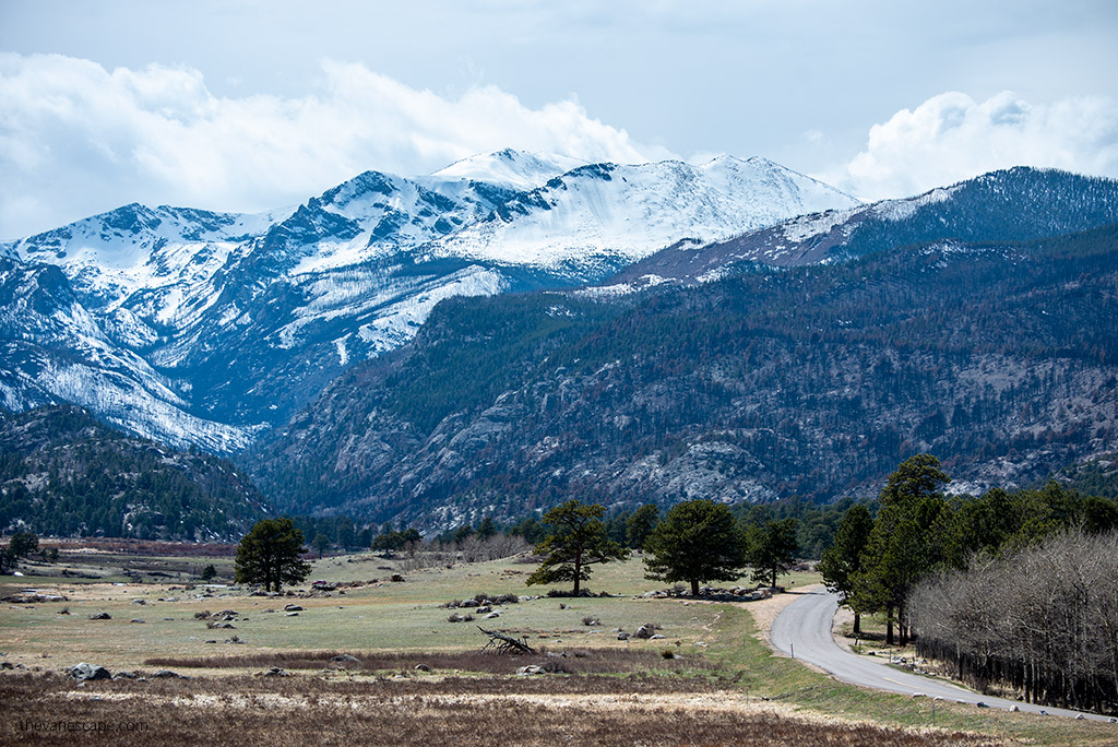 Bear Lake Road in Rocky Mountain with peaks covered by snow.