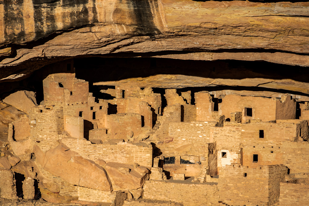 Cliff dwellings of Ancestral Puebloans in Mesa Verde National Park during sunset.