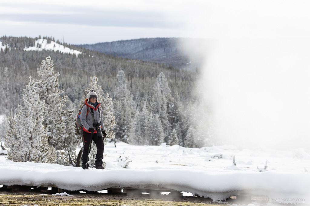 Agnes Stabinska, the author and the owner of this blog, is hiking along geyser during frosty winter in Yellowstone.