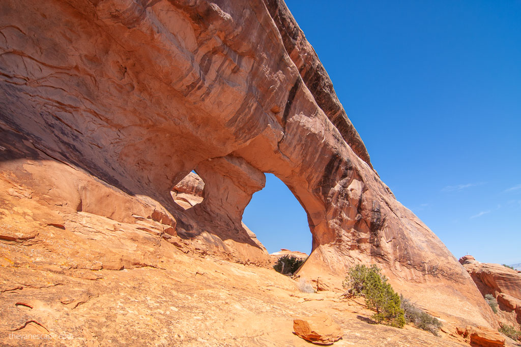 one of the best things to do in arches national park is hiking and admiring huge arches above head.