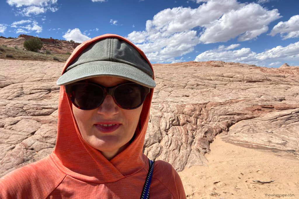 Agnes Stabinska, the author, in orange hoodie with sun protection sun hut and sunglasses, during  Zebra Slot Canyon hike.