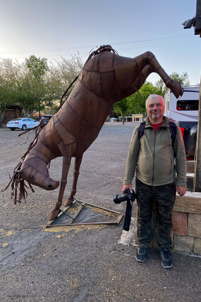 Chris Labanowski with metal horse sculpture in Kanab, Utah.