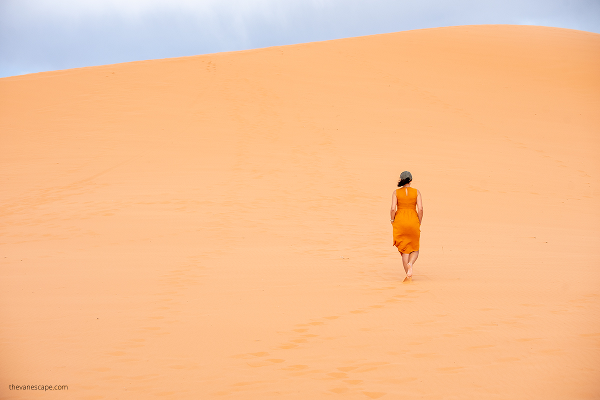 Agnes Stabinska, the author, is hiking on the deep sand in Coral Pink Sand Dunes State Park.