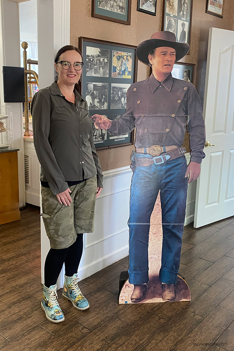 Agnes Stabinska, the author, in Parry Lodge with John Wayne poster.