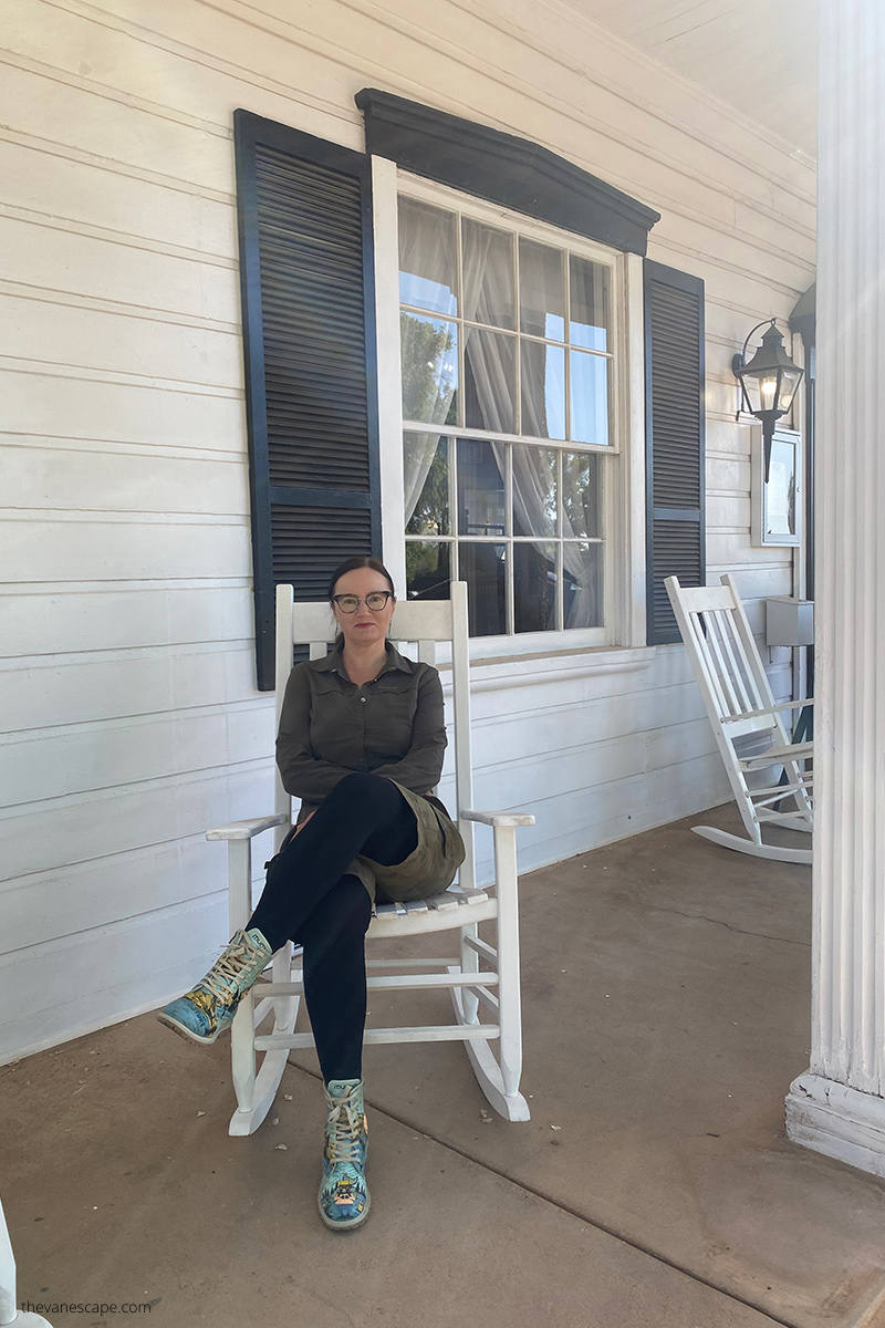 Agnes Stabinska, the author, is sitting on the white chair on the porch of Parry Lodge in Kanab.
