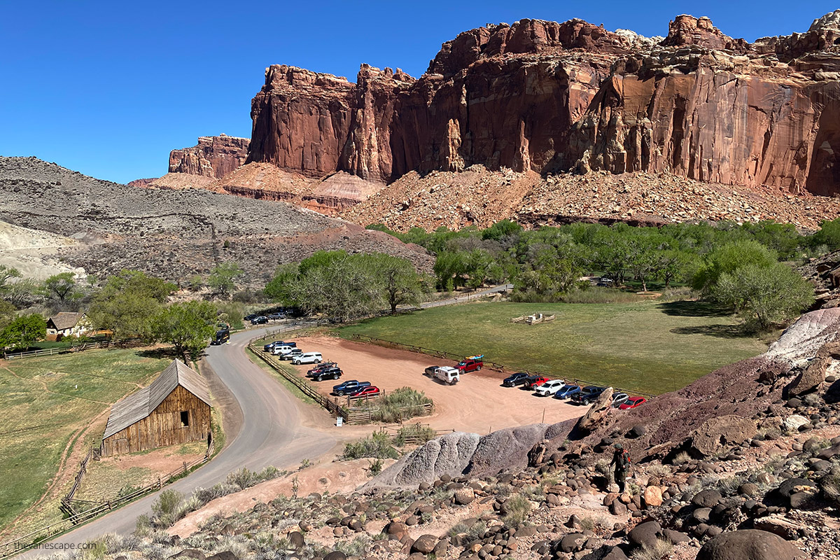 the large wooden barn - Pendleton Barn from the iking trail with the backdrop of huge walls of capitol reef.