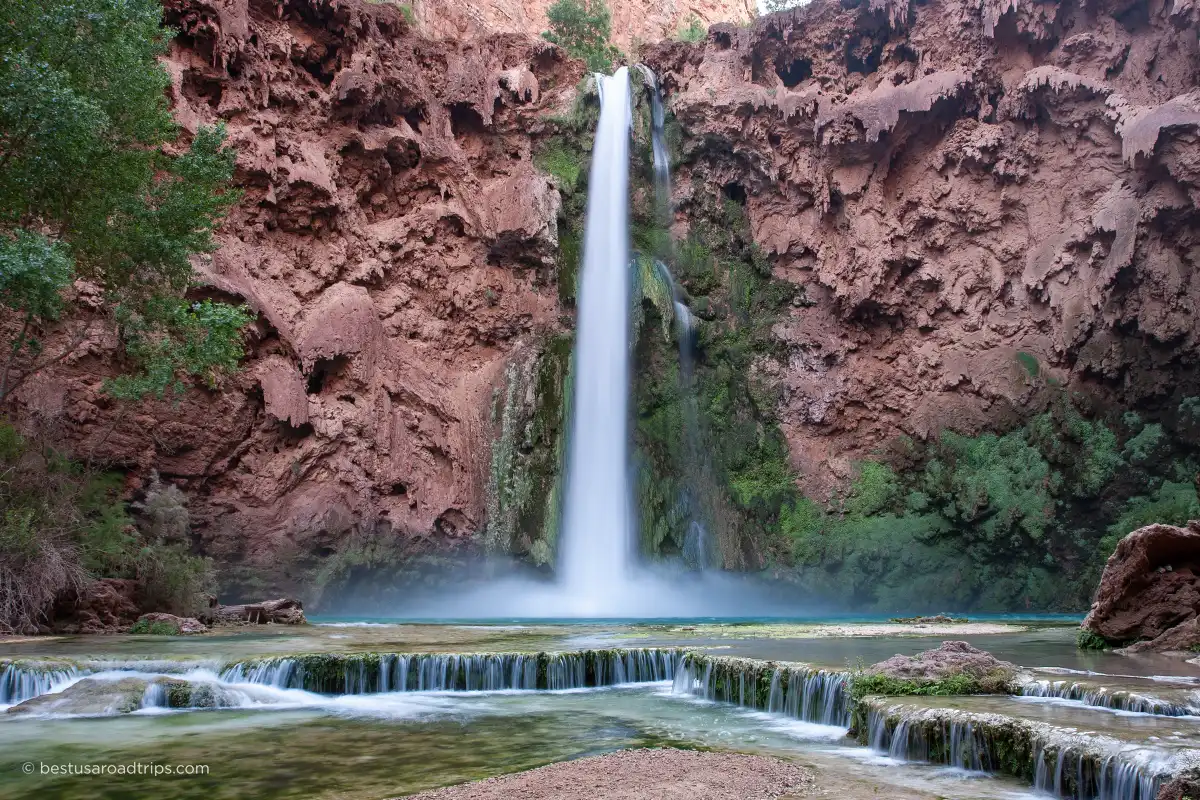 Mooney Falls in Havasu Creek - cascade of water, and dark brown walls.