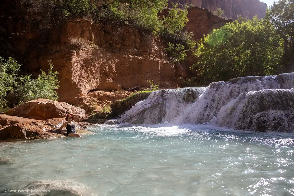 Author Agnes Stabinska swimming in the turquoise waters of a Havasupai waterfall along Havasu Creek.