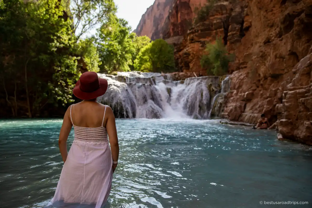 Agnes Stabinska, the author, wearing a hat and white dress at the Havasupai waterfalls.