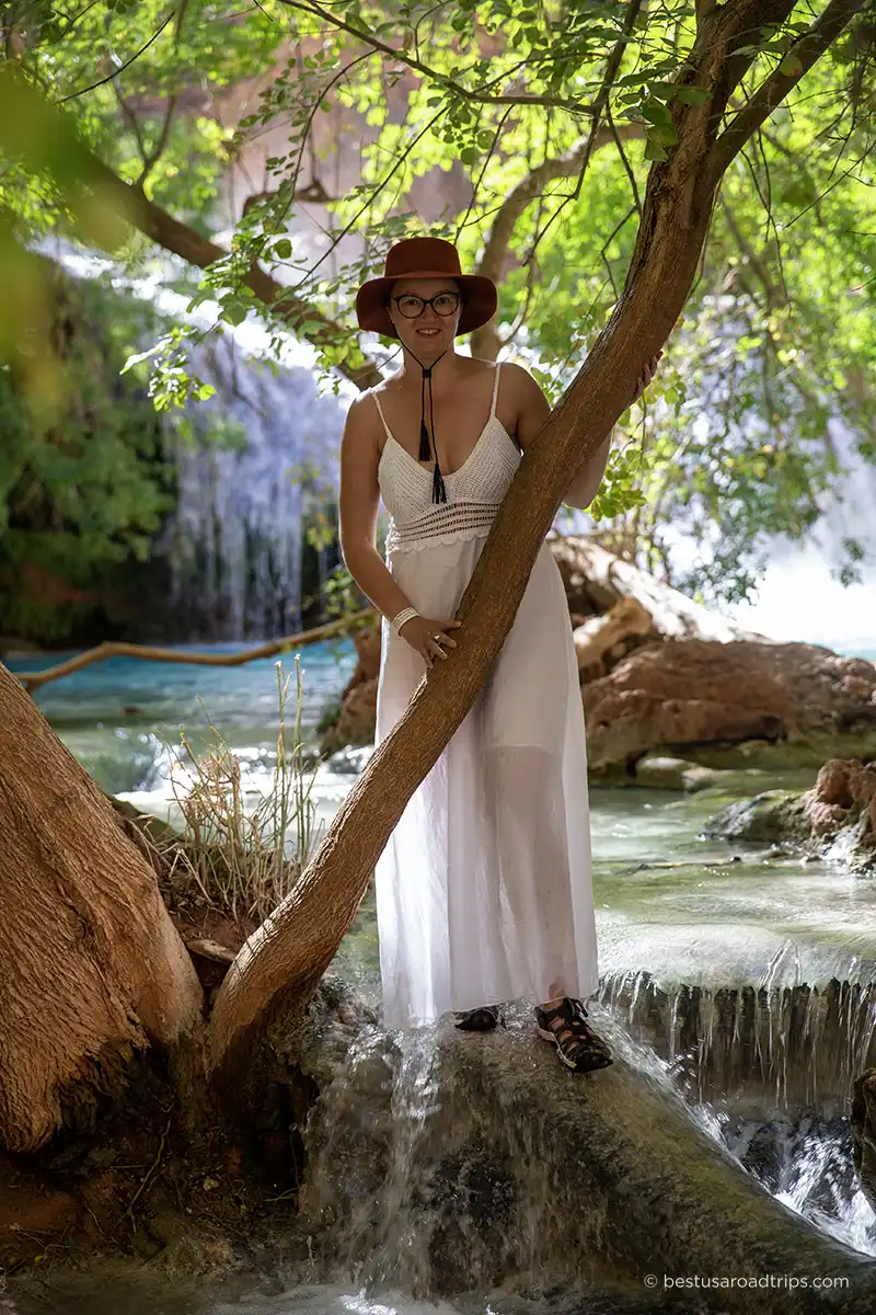 Agnes Stabinska wearing waterproof Keen sandals and a white dress, standing in Havasu Creek among trees.