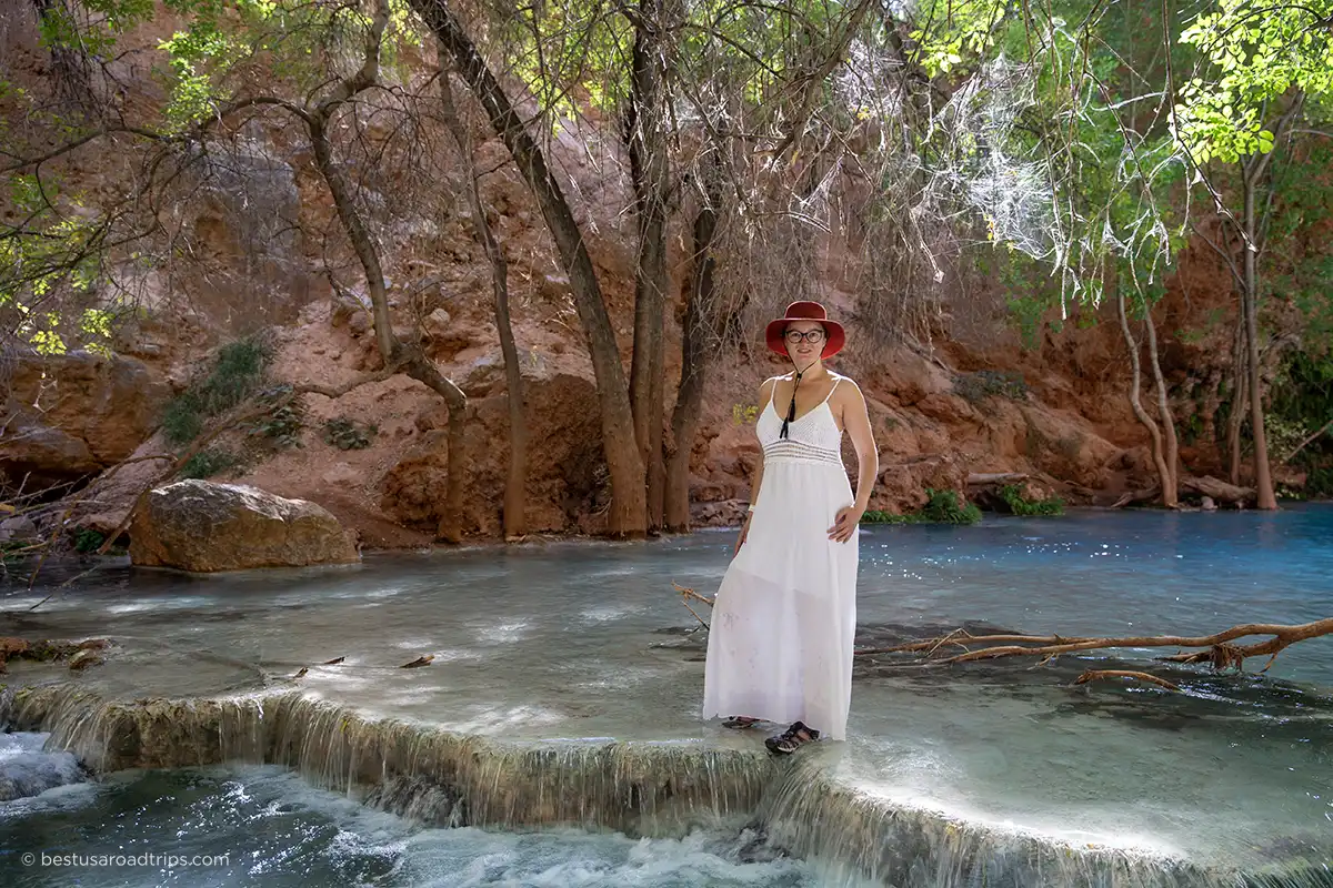 Agnes Stabinska standing in Havasu Creek wearing a white dress and waterproof Keen sandals.