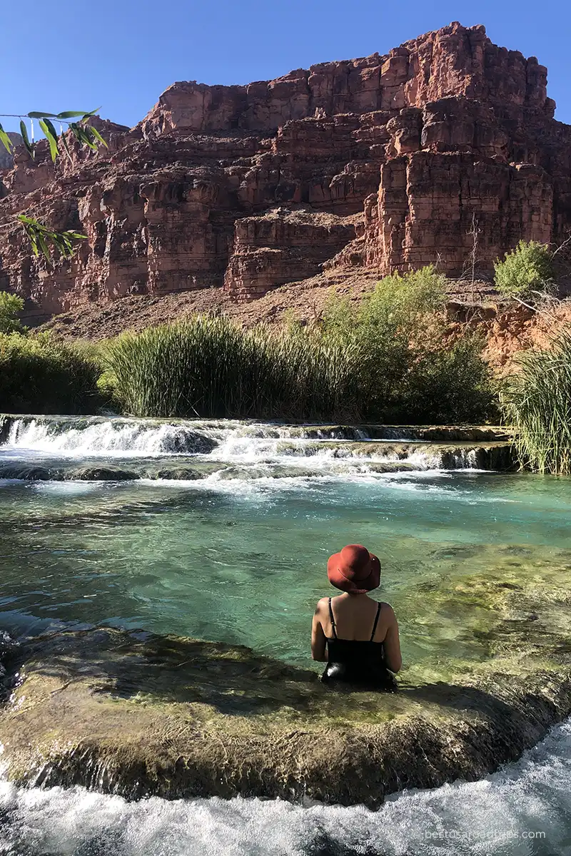 Agnes Stabinska wearing a swimsuit and hat while relaxing in the turquoise water of Havasu Creek.